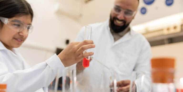 Father and daughter completing a hands-on experiment at a Life Science Centre Home Education Day.