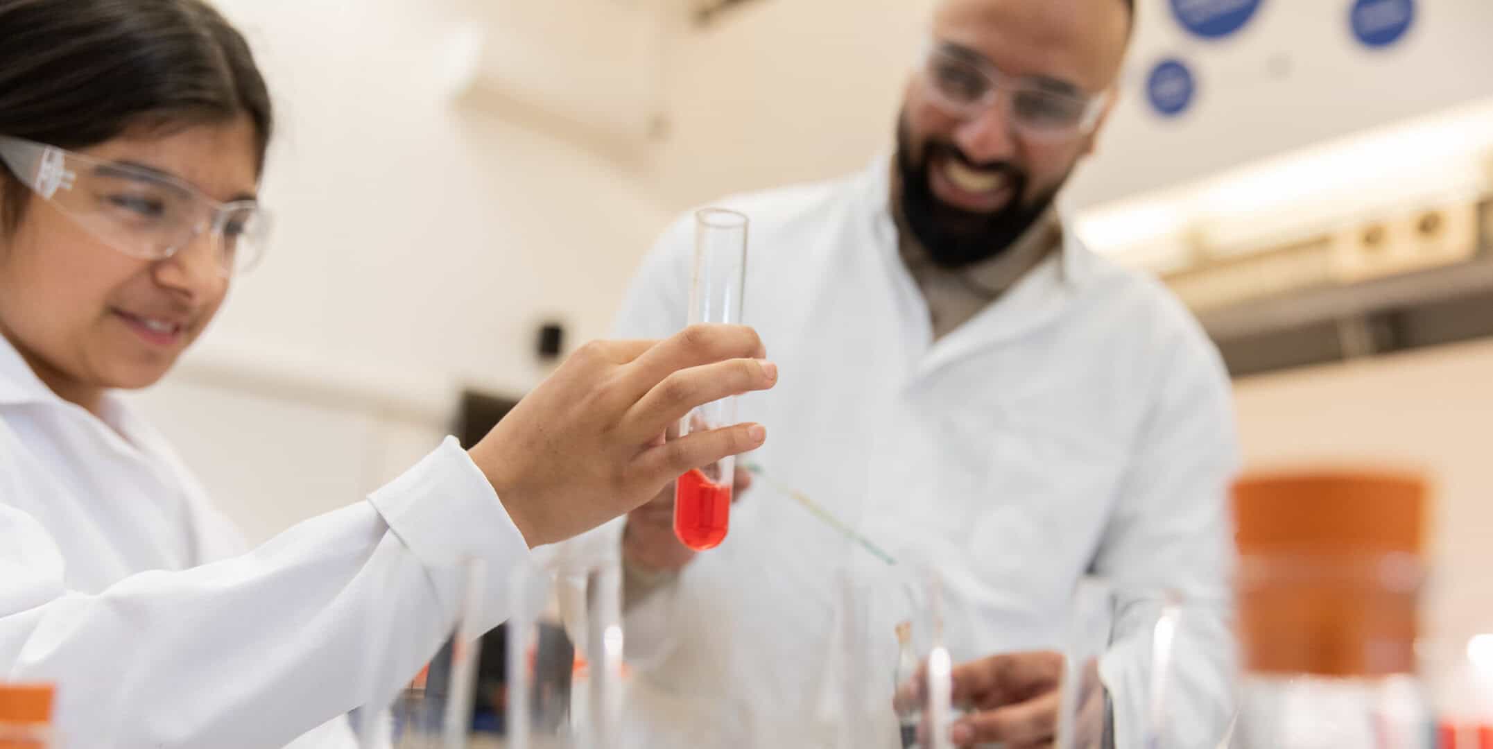 Father and daughter completing a hands-on experiment at a Life Science Centre Home Education Day.