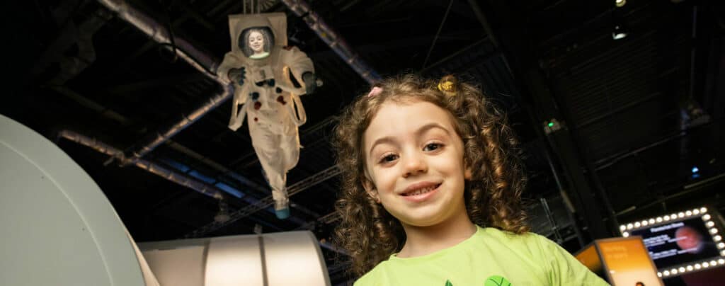 Little girl getting an astronaut selfie in Life's Space Zone.