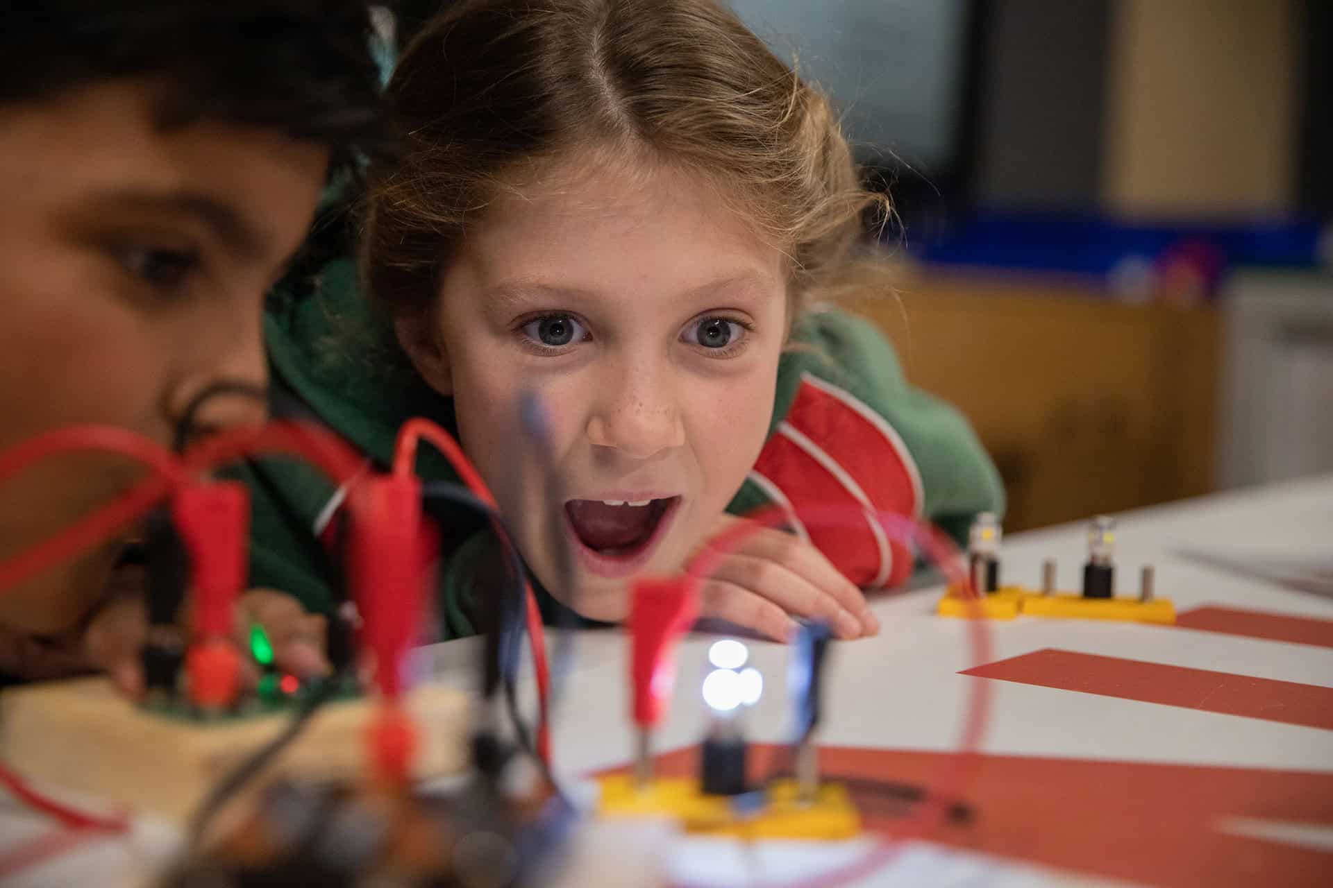 Girl looking amazed at electricity demonstration at Newcastle's Life Science Centre.
