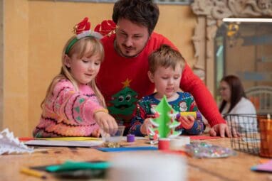 Family creating a Christmas tree decoration in Life Science Centre's Making Studios.