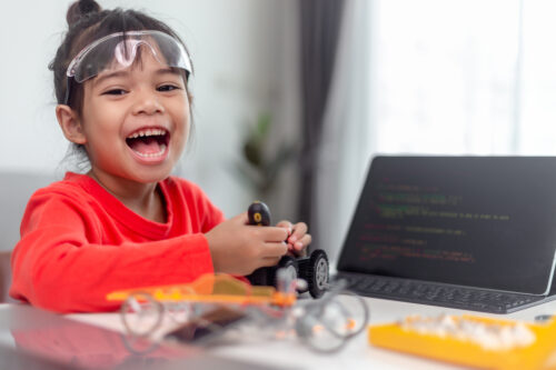 Asia Students Learn At Home In Coding Robot Cars And Electronic Board Cables In STEM, STEAM, Mathematics Engineering Science Technology Computer Code In Robotics For Kids Concept.