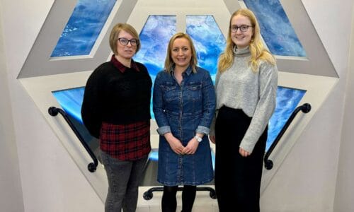 The People Team stood in Life Science Centre's International Space Station mock up window.