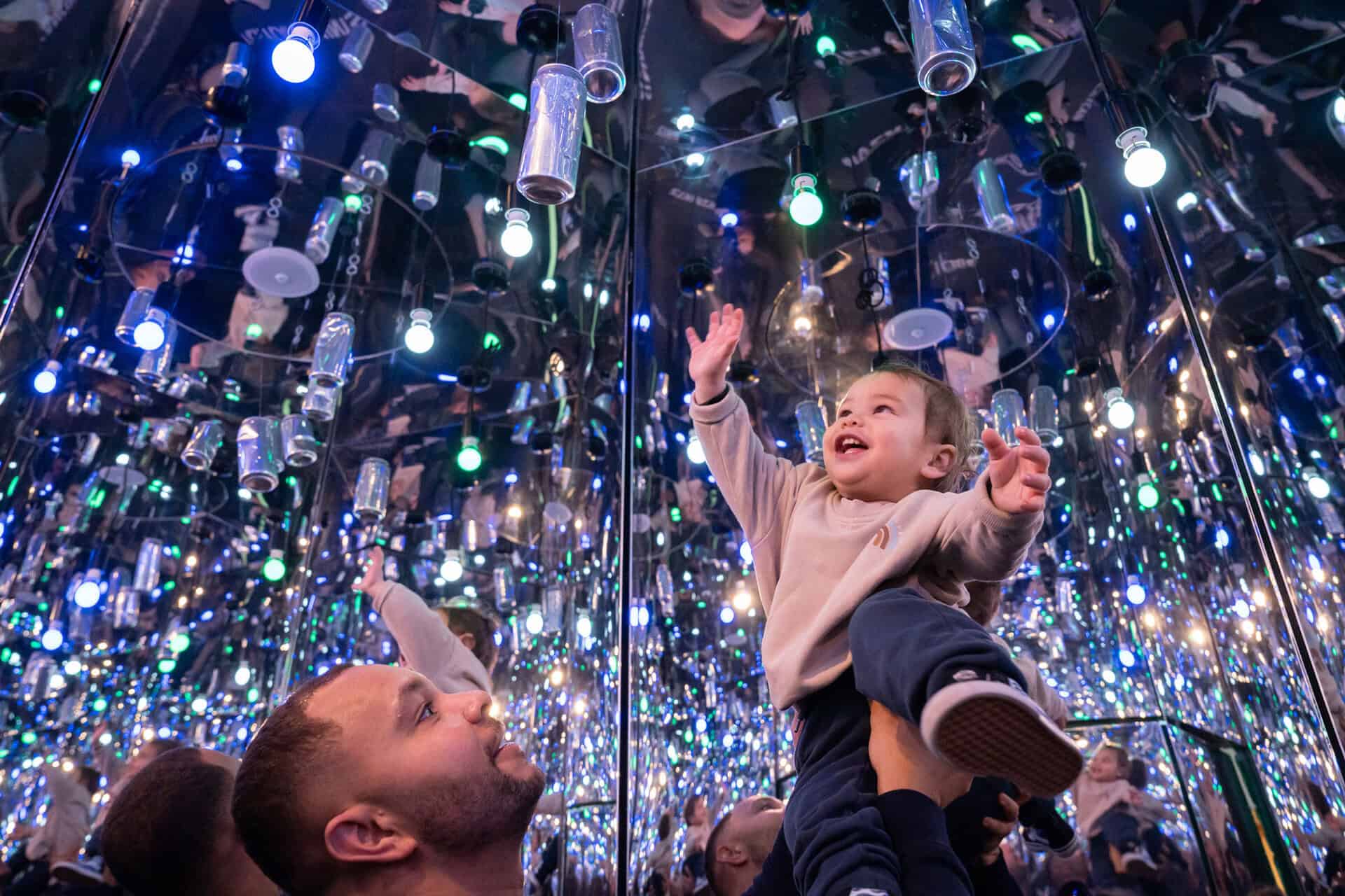 Parent and child looking up in Infinity Room - a new interactive exhibit at Newcastle's Life Science Centre.