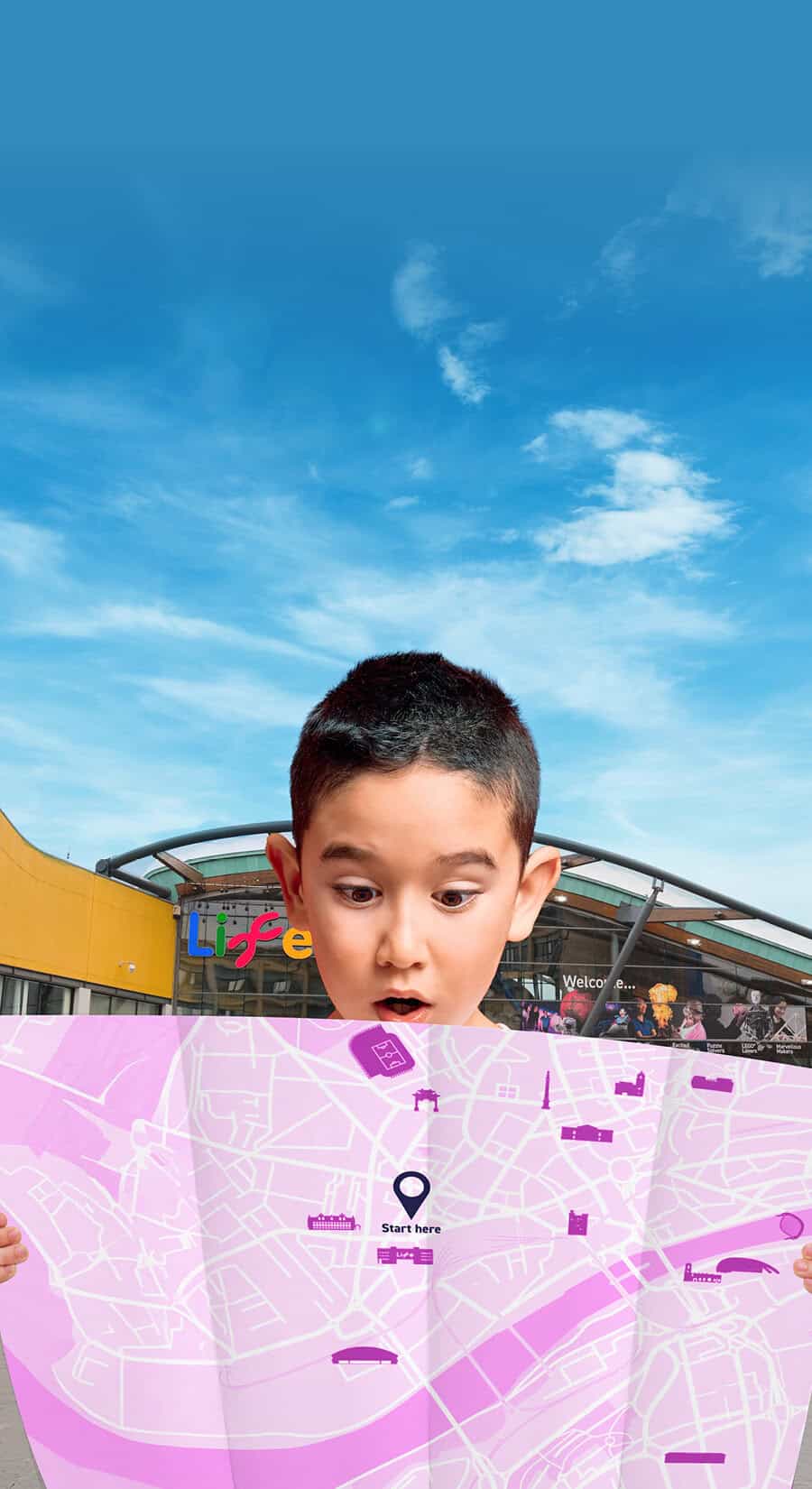 Young boy looking at pink map to find where hidden tickets are