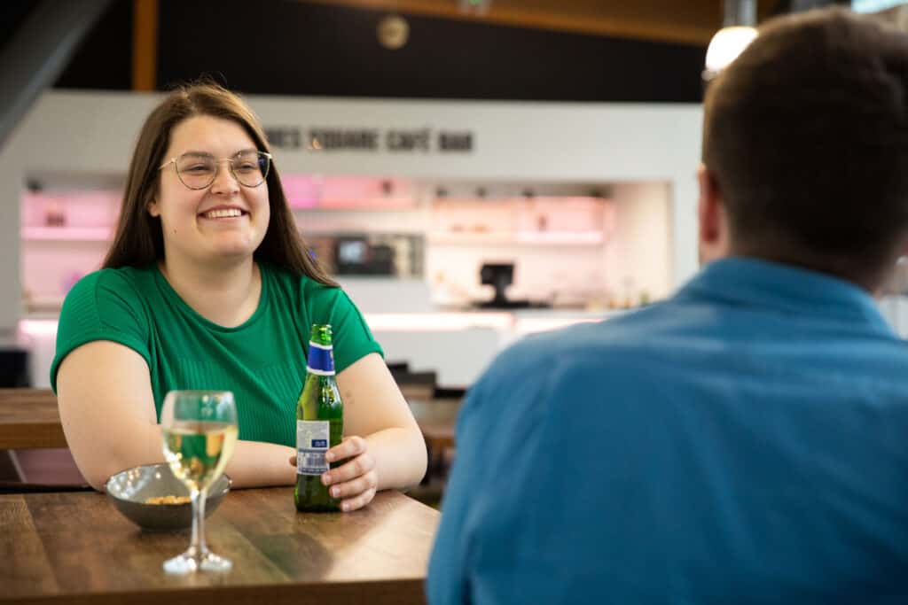 Adults enjoying a beer in Life Science Centre's bar area.