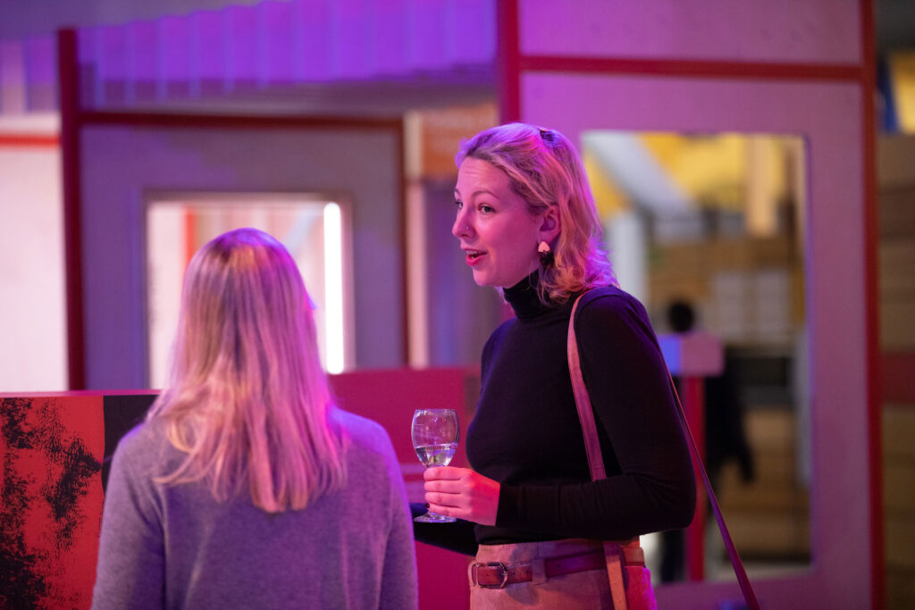 Adults In Science Centre Chatting And Enjoying A Drink.