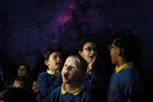 Edina school children in Life Science Centre's mobile Planetarium, looking up in amazement at the stars and planets.