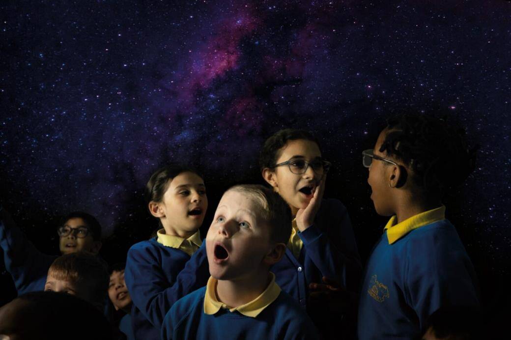 Edina school children in Life Science Centre's mobile Planetarium, looking up in amazement at the stars and planets.
