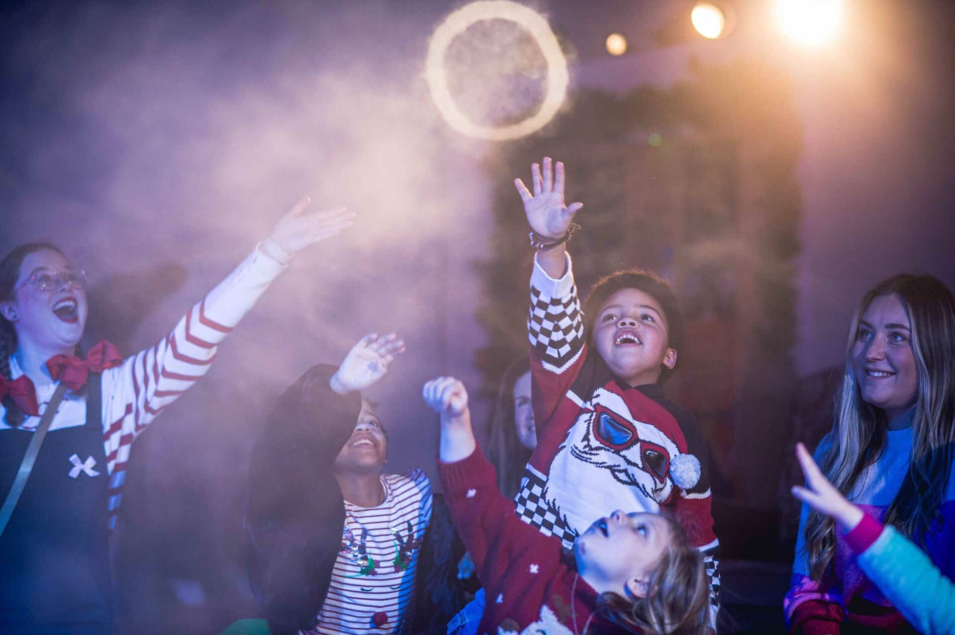 Children playing with smoke rings during a Santa Experience session at Newcastle's Life Science Centre.