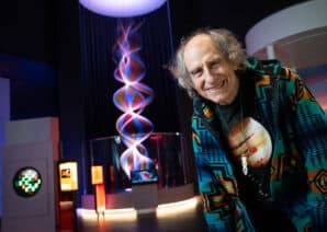 Artist Paul Friedlander pictured in front of String of Waves exhibit in Lightbox