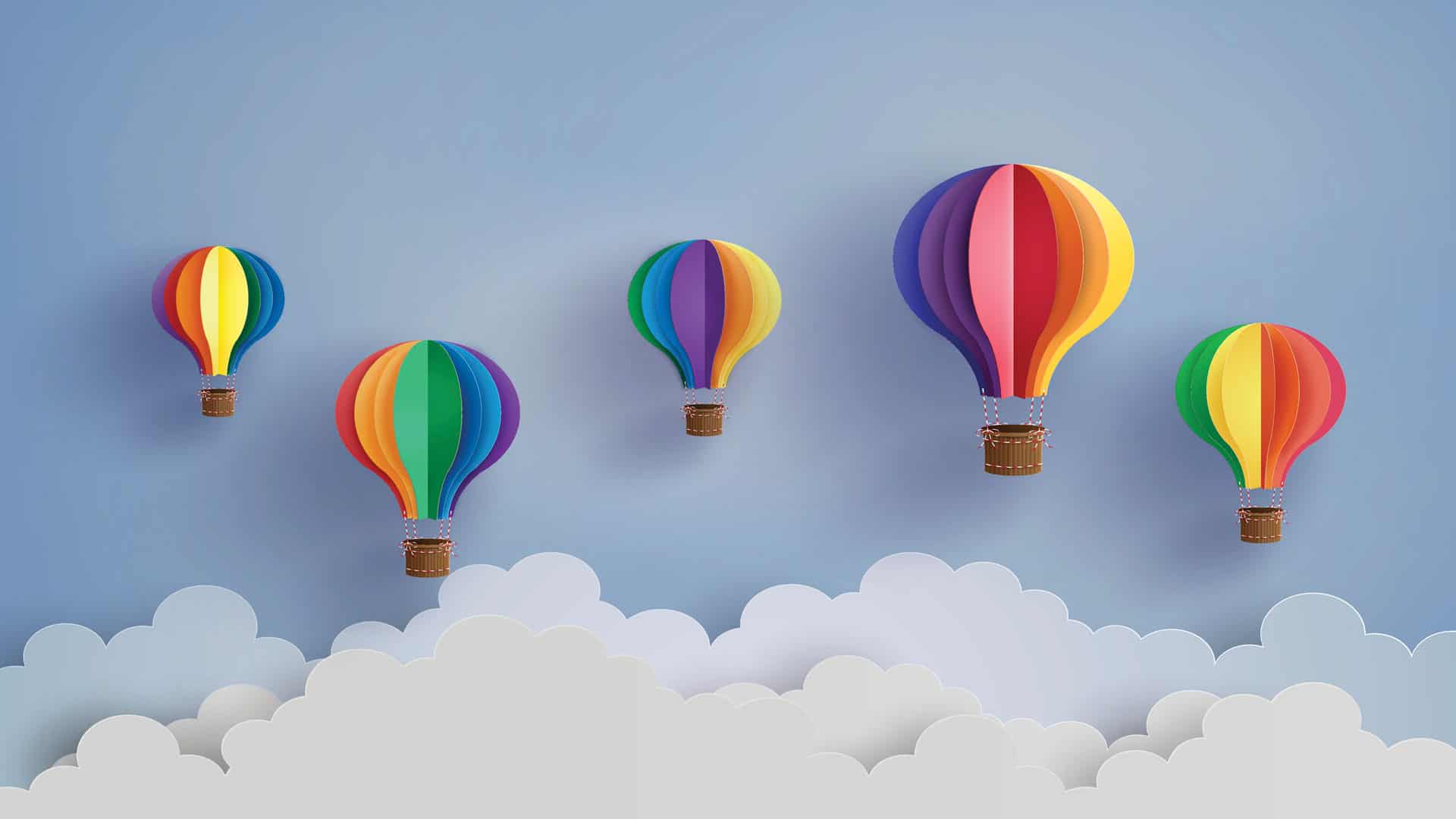 5 rainbow coloured paper hot air balloons floating in the clouds