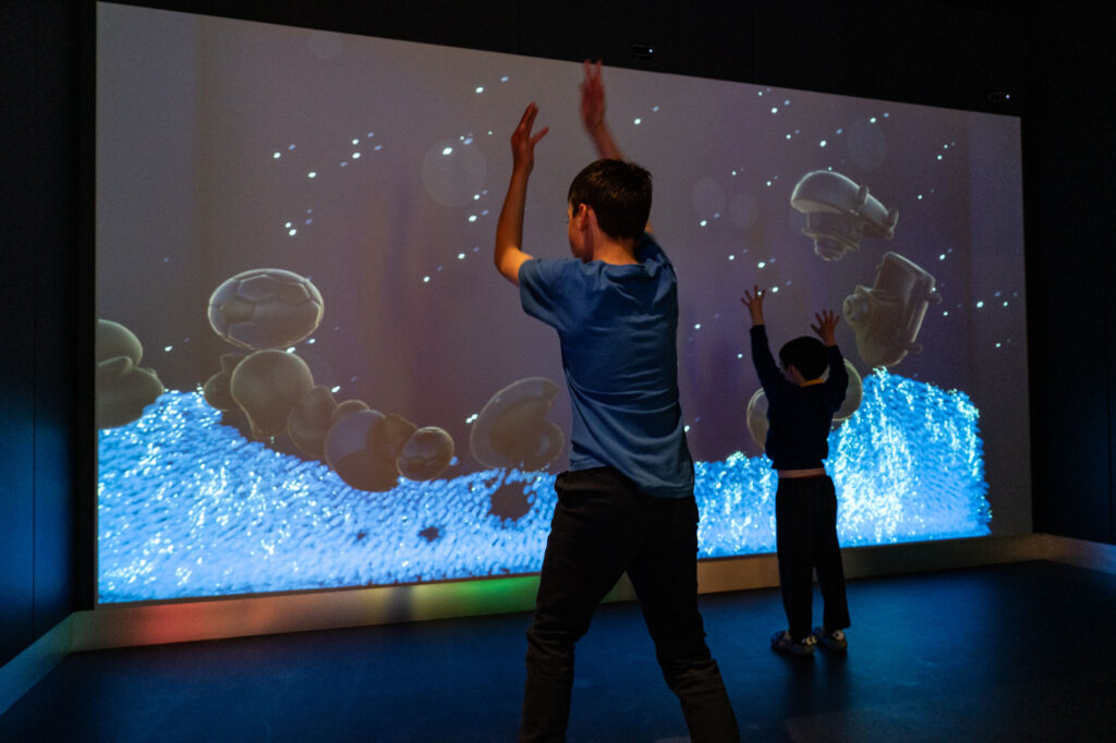 Children interacting with digital screen at Life Science Centre.