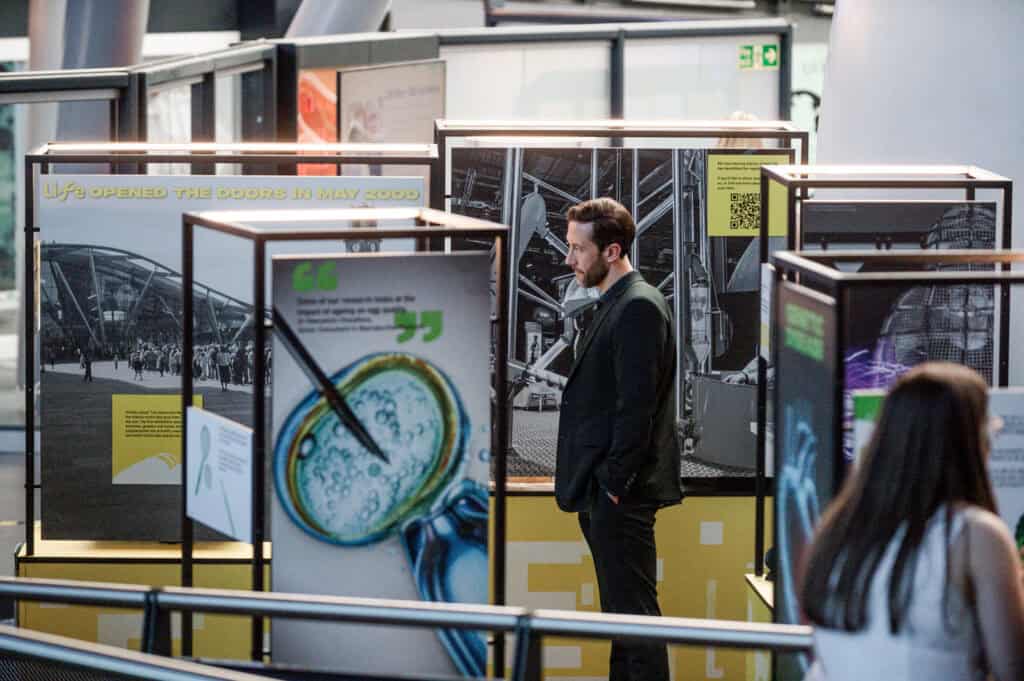 Man reading about the story of Life in Newcastle's Life Science Centre.