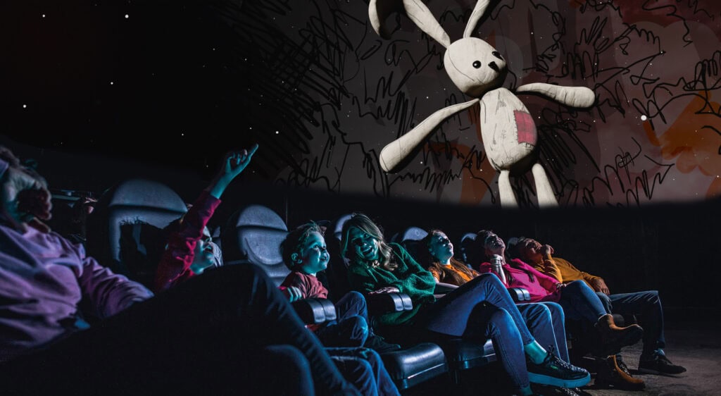 Family in Life Science Centre Planetarium looking up at at bunny toy which features in in Bump in the Night show.