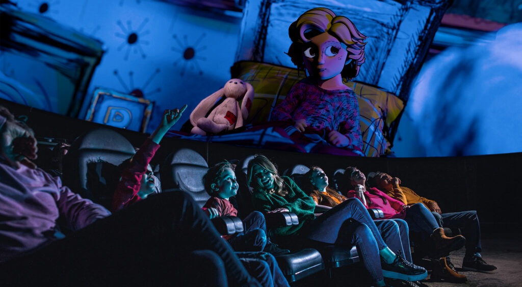 Family in Life Science Centre Planetarium looking up at animated girl in bed with bunny in Bump in the Night show.