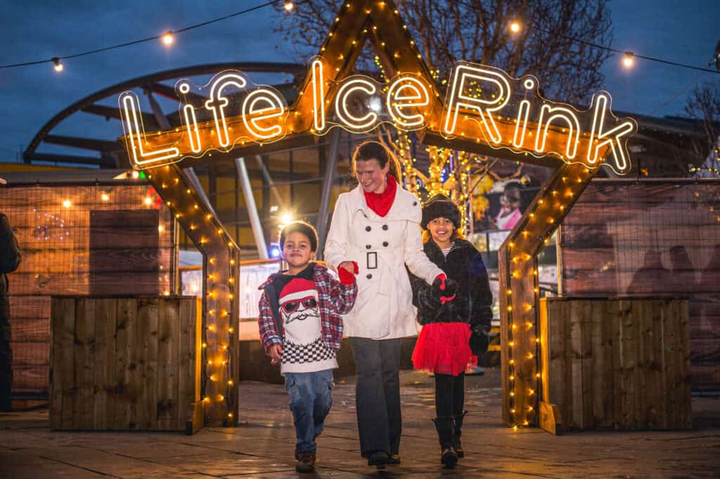 Family walking through star entrance of Life Science Centre's outdoor ice rink.