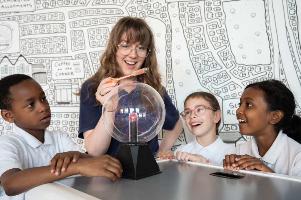 Lauren McNaughton pictured with students from the West End Schools' Trust doing a hands-on science experiment all about electricity.
