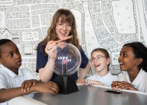 Lauren McNaughton pictured with students from the West End Schools' Trust doing a hands-on science experiment all about electricity.