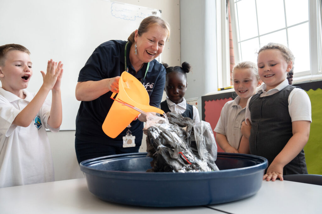 Nichola Peaker of Newcastle's Life Science Centre surrounded by children from West End schools' which completing a lively science experiment with water.