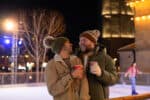 Male couple enjoying a festive hot chocolate at Life Science Centre's ice rink, located in Newcastle city centre.