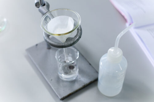 Separating By Filtration The Component Substances From Liquid Mixture In Lab.