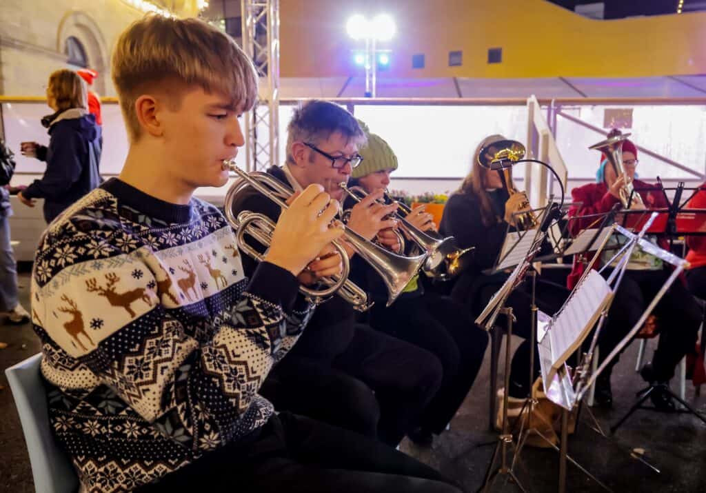 Brass band at outdoor ice rink.