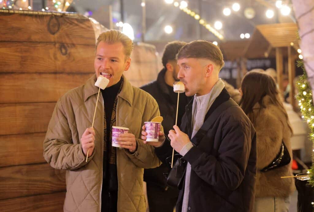 Couple eating marshmallows at Newcastle's outdoor ice rink.