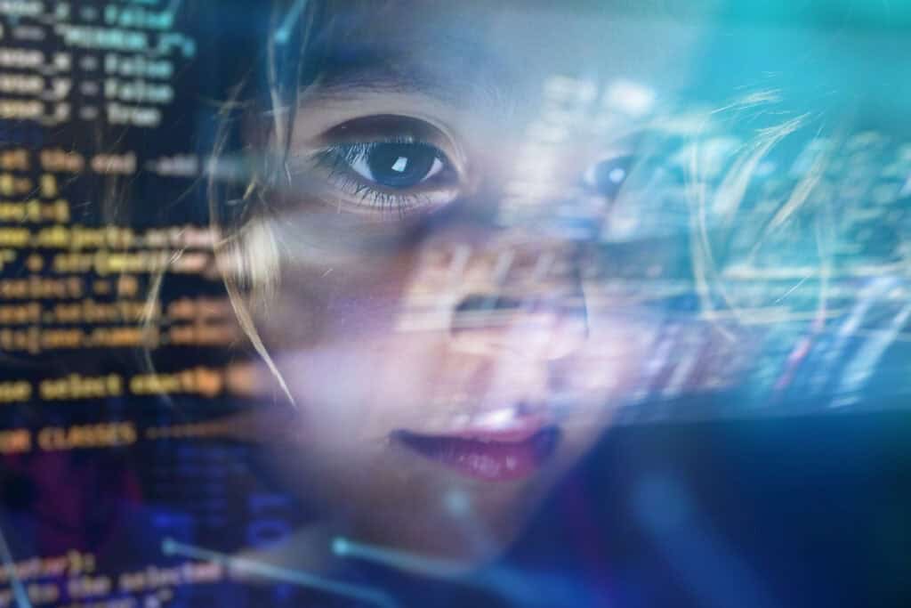 Close Up Of A Little Girl Looking At Some Futuristic coding on a screen
