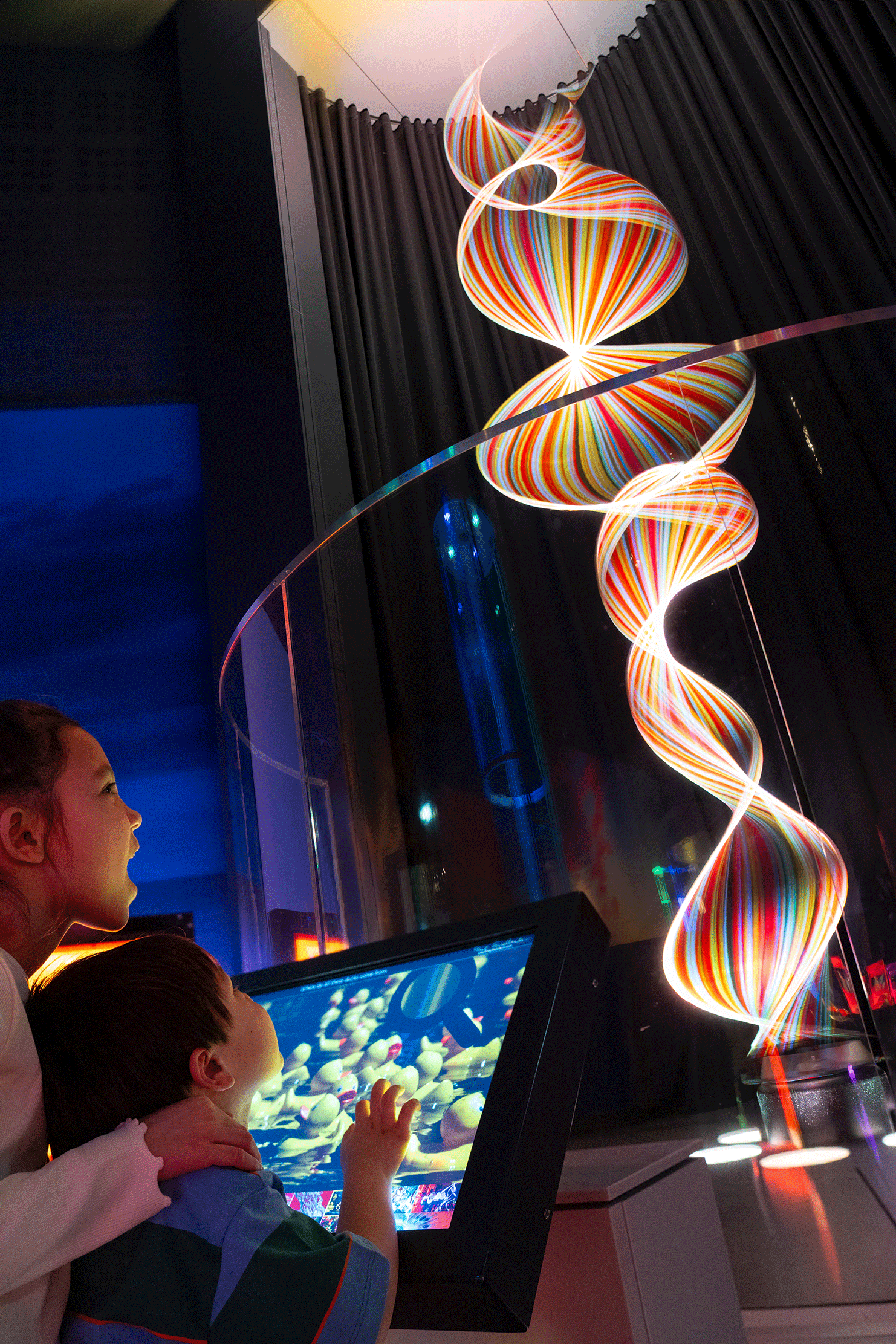 Brother and sister marvelling at 'String Wave' in Newcastle Life Science Centre's Lightbox exhibit.