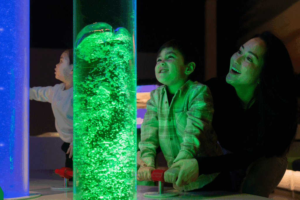 Little boy and mum creating bubbles in Newcastle's Life Science Centre Lightbox exhibit.