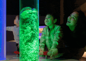 Little boy and mum creating bubbles in Newcastle's Life Science Centre Lightbox exhibit.