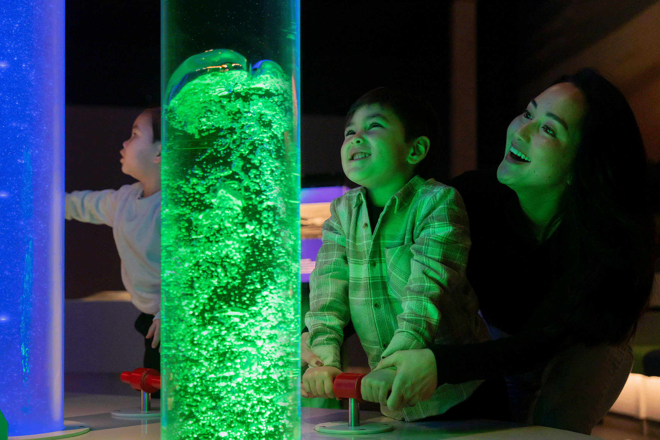 Little boy and mum creating bubbles in Newcastle's Life Science Centre Lightbox exhibit.