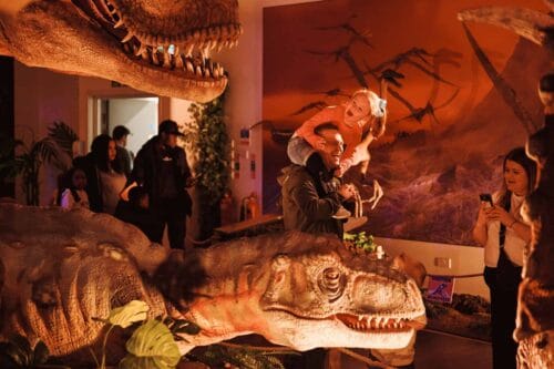 Family taking a photo of a juvenile T. rex at Newcastle's Life Science Centre
