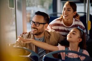 Happy Family Enjoying In Ridding In A Bus.