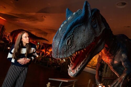 Woman looking at a huge dinosaur replica at Newcastle's Life Science Centre