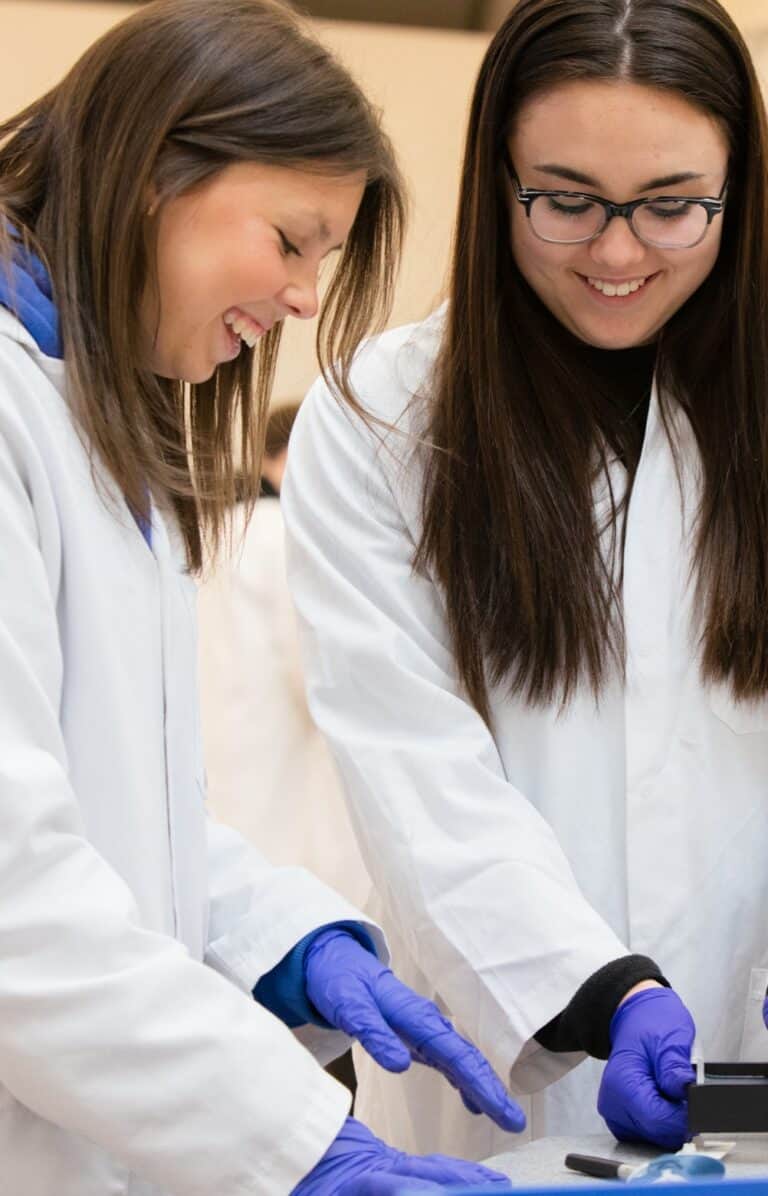 Two female students conducting hands-on PCR experiment in Life Science Centre workshop.