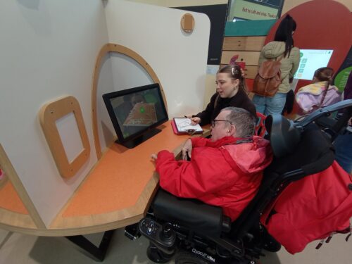 Wheelchair user accompanied by carer in Newcastle's Life Science Centre.