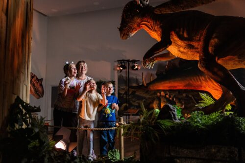 Children growling at animatronic dinosaur at Newcastle's Life Science Centre.