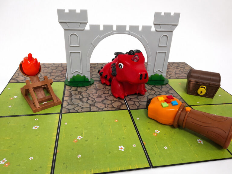 A cartoon draggon toy with a remote control being pointed at it in a cartoon castle setting.